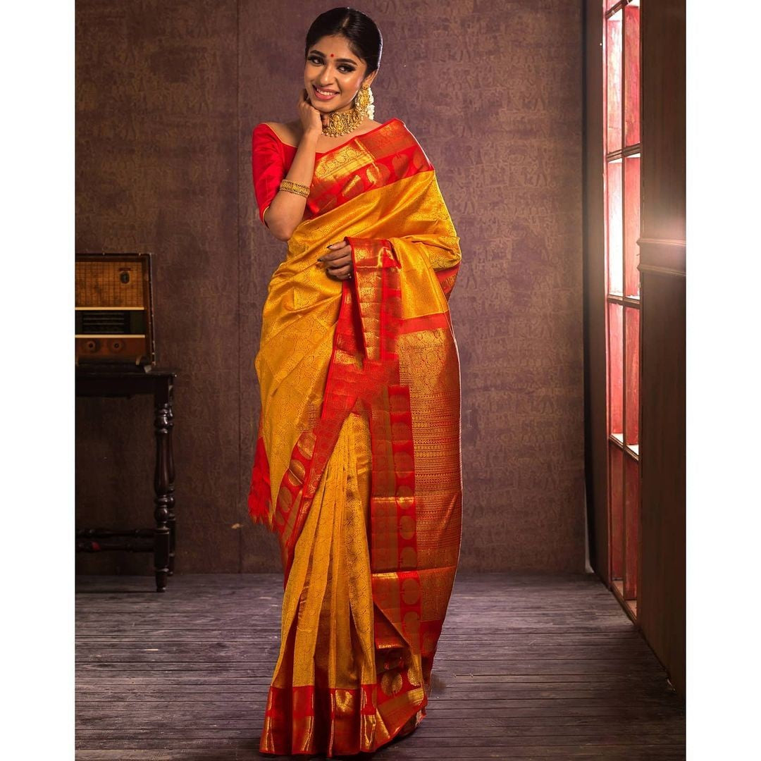 Adorning Yellow Soft Banarasi Silk Saree With Flattering Blouse Piece