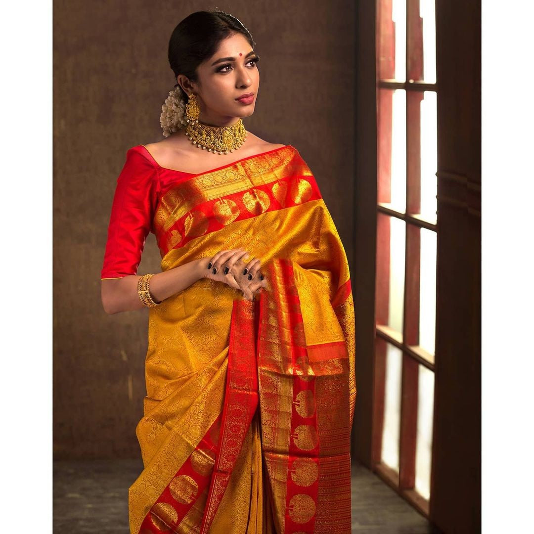 Adorning Yellow Soft Banarasi Silk Saree With Flattering Blouse Piece